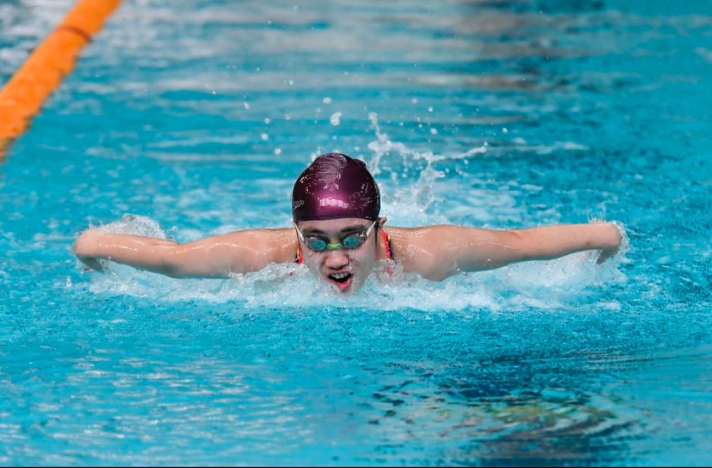 Competitive swimmer training in a 50m pool with a 02H Swim School coach in Singapore