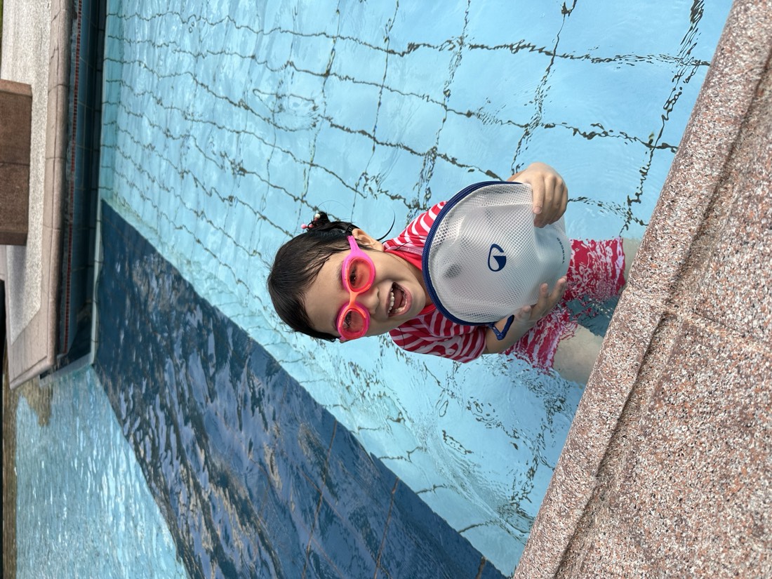 Young swimmer practising freestyle at a 02H lesson in Singapore